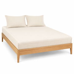 Ivory fine-dobby textured bed sheet set with matching pillowcases on a wooden bed