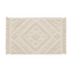 Ivory geometric tufted bath mat with textured pattern on white background