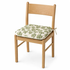 Primeval ivory and green botanical tufted dining chair pad with tie straps on wooden dining chair