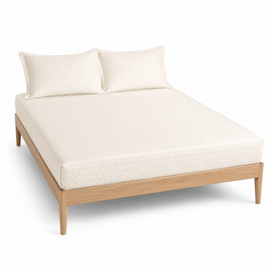 Ivory micro-diamond textured bed sheet set with matching pillowcases on a wooden bed