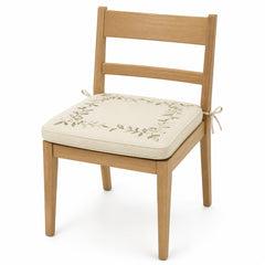 Primeval ivory and olive botanical border dining chair pad with tie straps on wooden dining chair