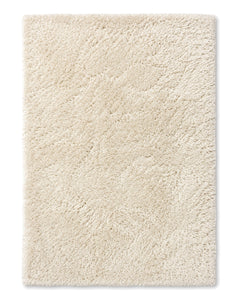 Ivory shaggy area rug with a plush deep-pile surface and subtle textured finish on a white background.