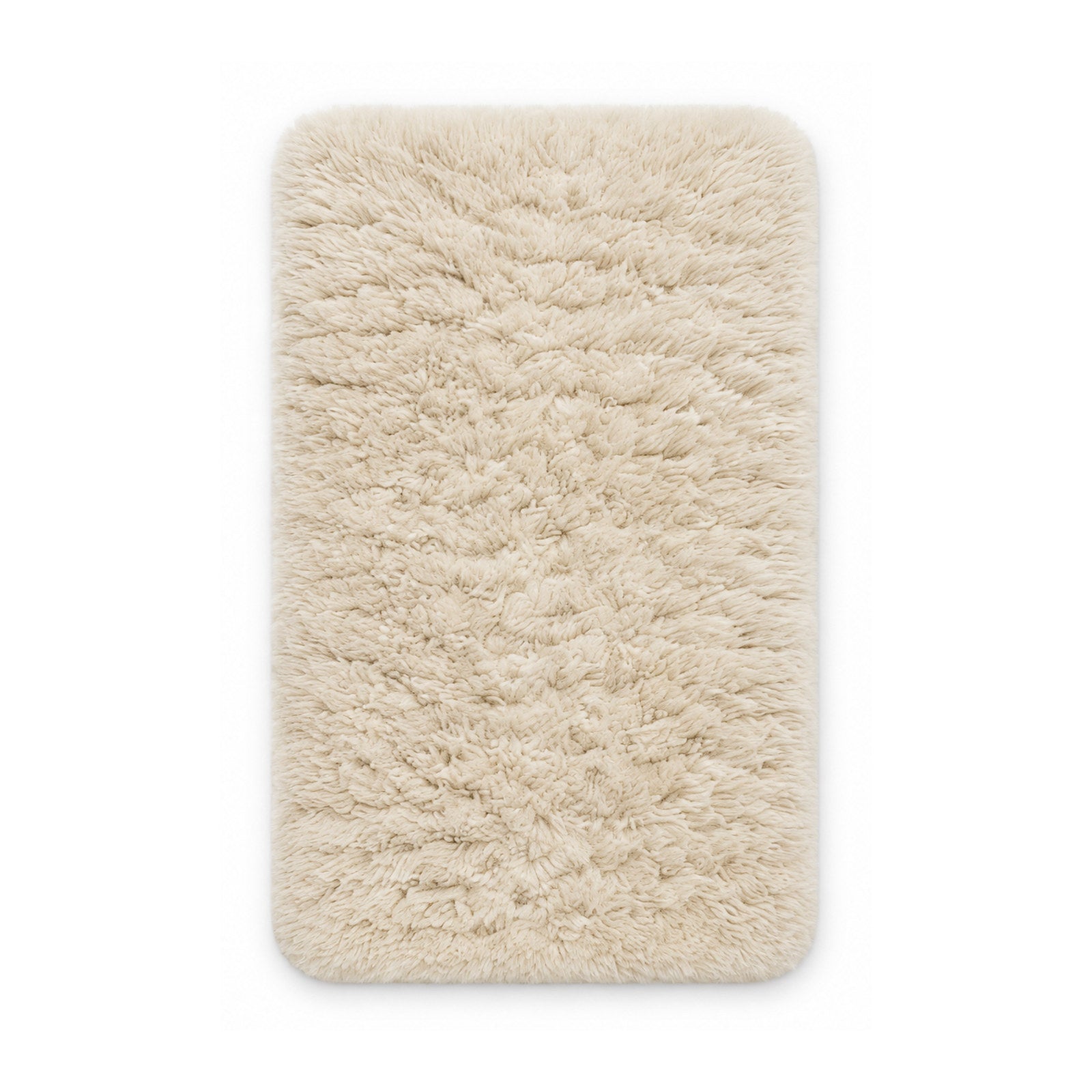 Ivory plush shag bath mat on white background