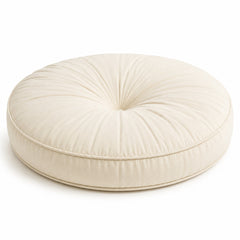 Ivory round floor cushion with central tufting and gathered top on white background