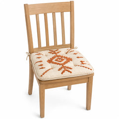 Primeval ivory and rust tribal pattern dining chair pad with tie straps on wooden dining chair