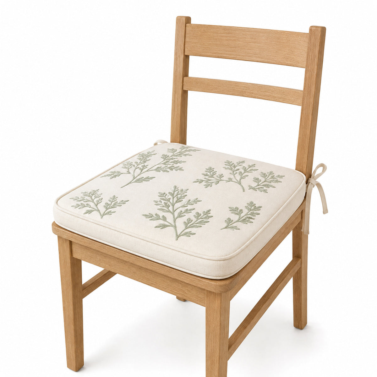 Primeval ivory and sage botanical dining chair pad with tie straps on wooden dining chair