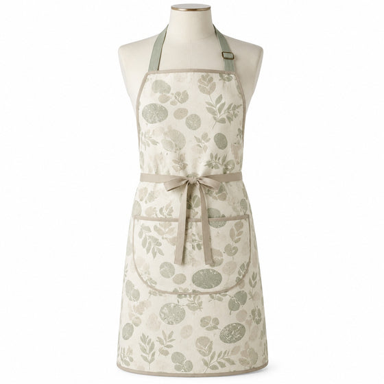 Primeval ivory chef apron with sage organic print displayed on a dress form