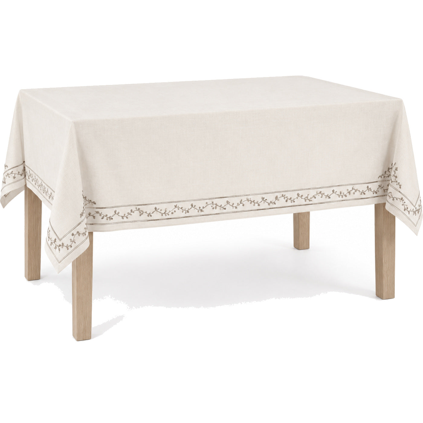 Primeval ivory taupe elegant embroidered border tablecloth displayed on a rectangular dining table