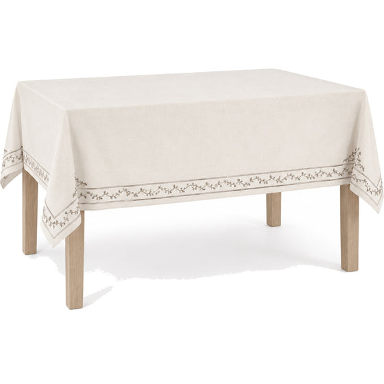 Primeval ivory taupe elegant embroidered border tablecloth displayed on a rectangular dining table