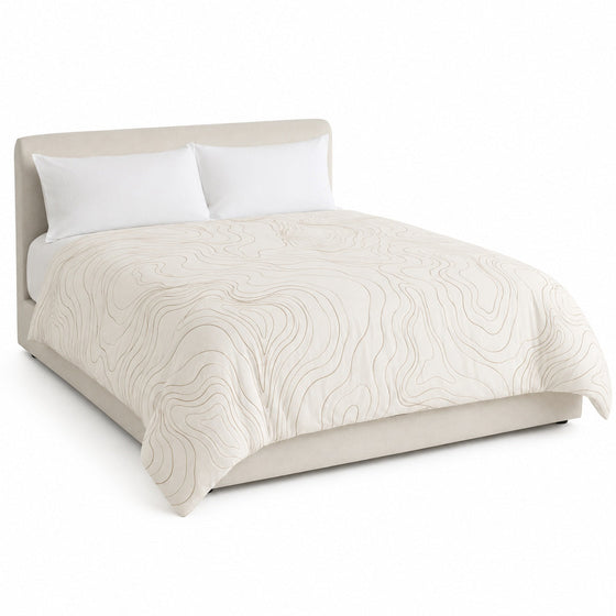 Primeval ivory and taupe organic contour duvet cover displayed on a styled bed against a clean white studio background