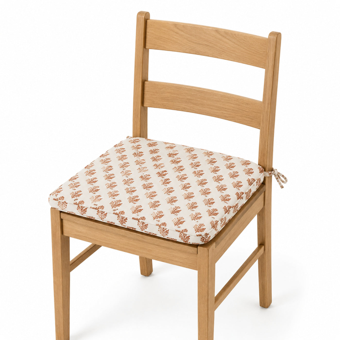 Primeval ivory and terracotta block print dining chair pad with tie straps on wooden dining chair