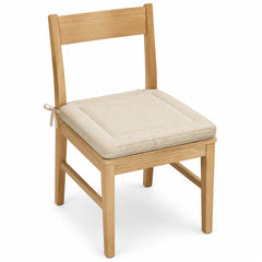 Primeval ivory textured border dining chair pad with tie straps on wooden dining chair