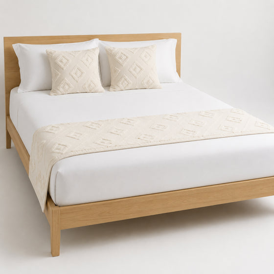 Ivory tonal floral bed runner styled on white bedding for wholesale boutique hotel, hospitality and private-label sourcing