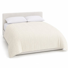 Primeval ivory vertical textured stripe duvet cover displayed on a styled bed against a clean white studio background