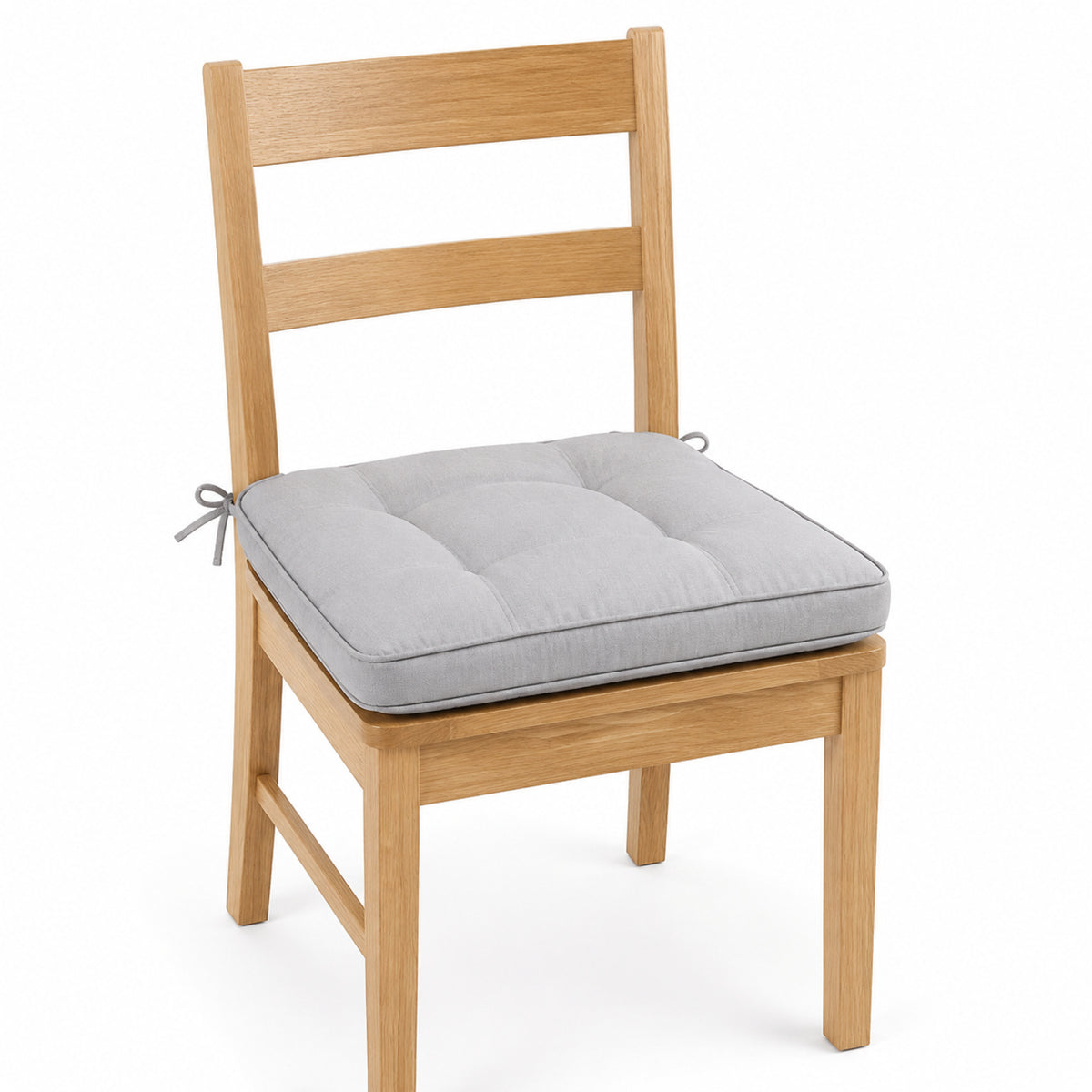 Primeval light grey tufted dining chair pad with tie straps on wooden dining chair