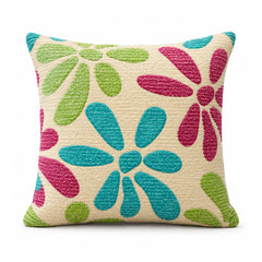 Primeval decorative cushion with large turquoise pink and lime green stylized flowers on a light ivory background
