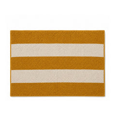 Mustard and cream striped bath mat on white background