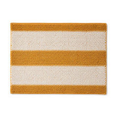 Mustard yellow and ivory striped textured bath mat on white background