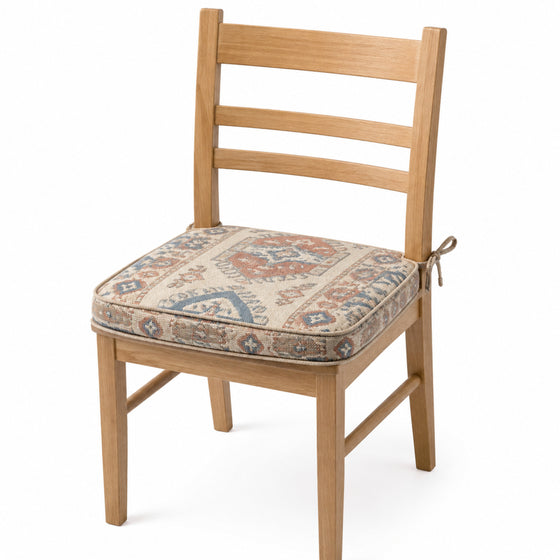 Primeval muted blue and rust vintage medallion dining chair pad with tie straps on wooden dining chair