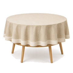 Primeval natural beige cream border tablecloth displayed on a round dining table