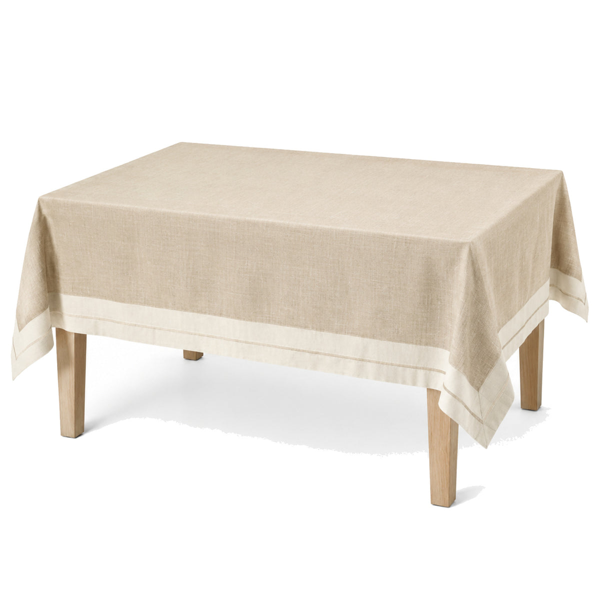 Primeval natural beige ivory border tablecloth displayed on a rectangular dining table