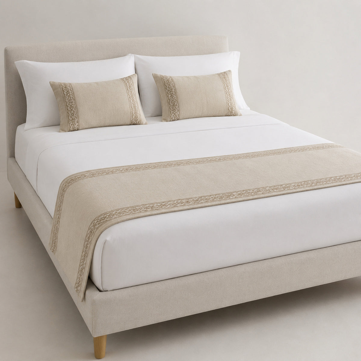 Natural beige minimalist border bed runner styled on white bedding for wholesale hotel, hospitality and private-label sourcing