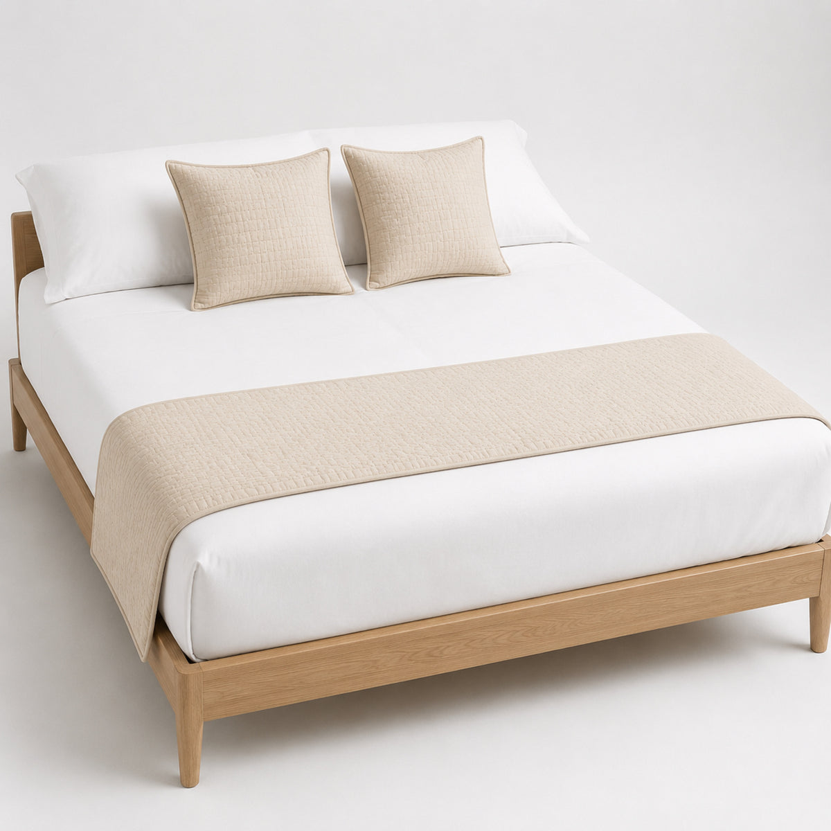 Natural beige solid-texture bed runner, styled across a white bed for wholesale hotel and private-label bedding sourcing