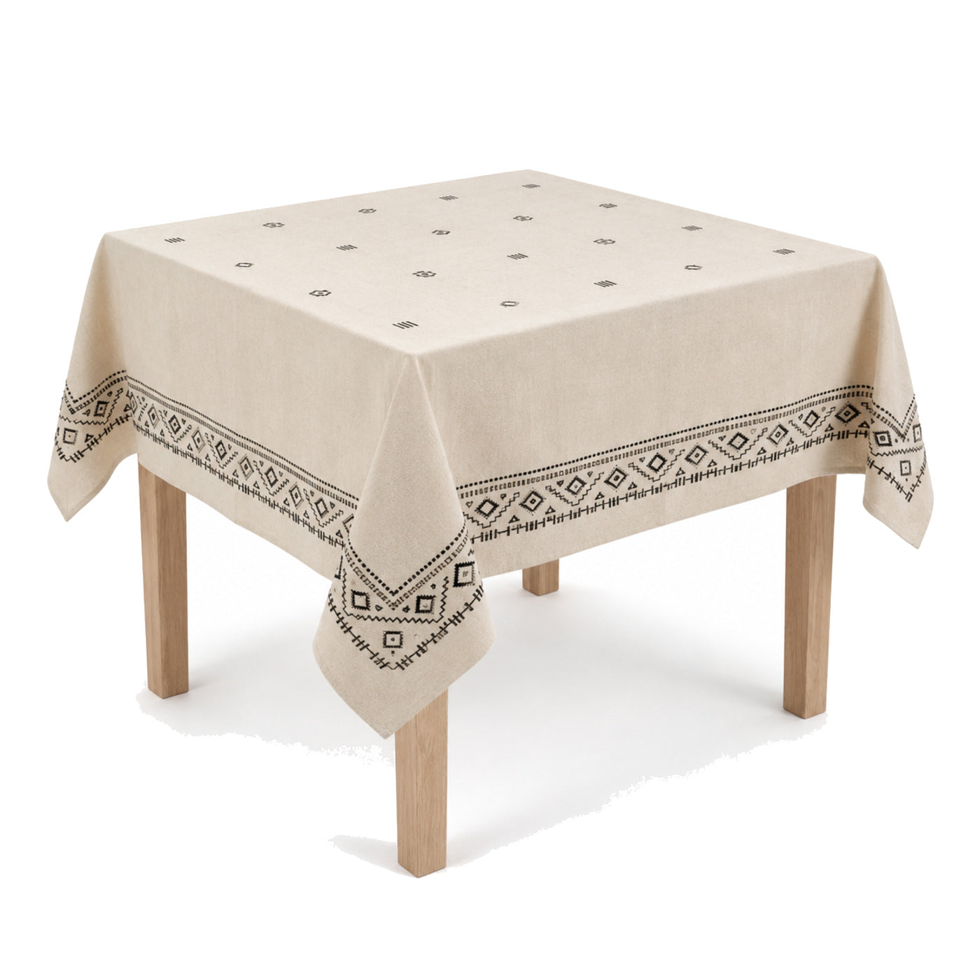 Primeval natural black geometric embroidery tablecloth displayed on a square dining table