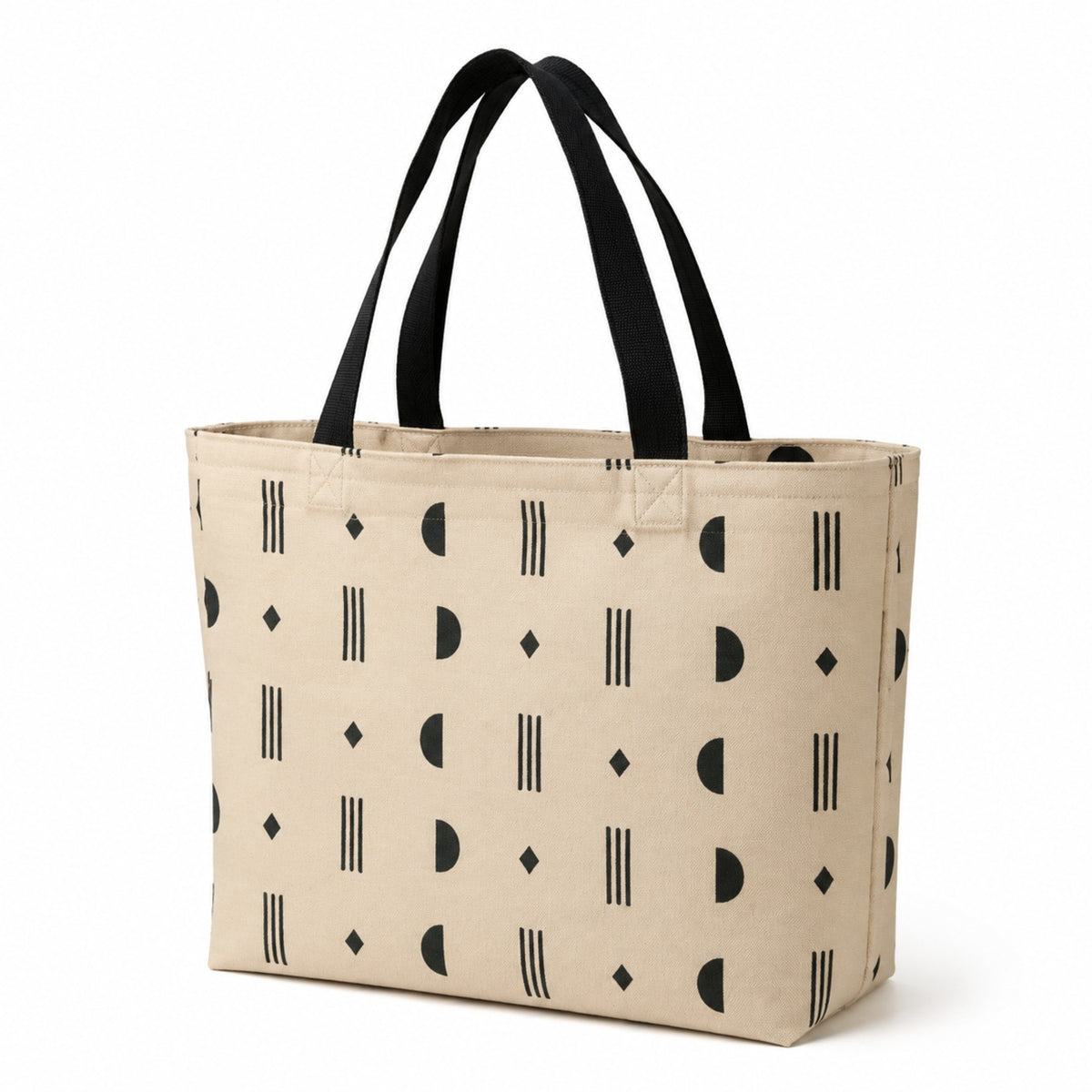 Natural tote bag with black abstract geometric print and black handles on a white background.