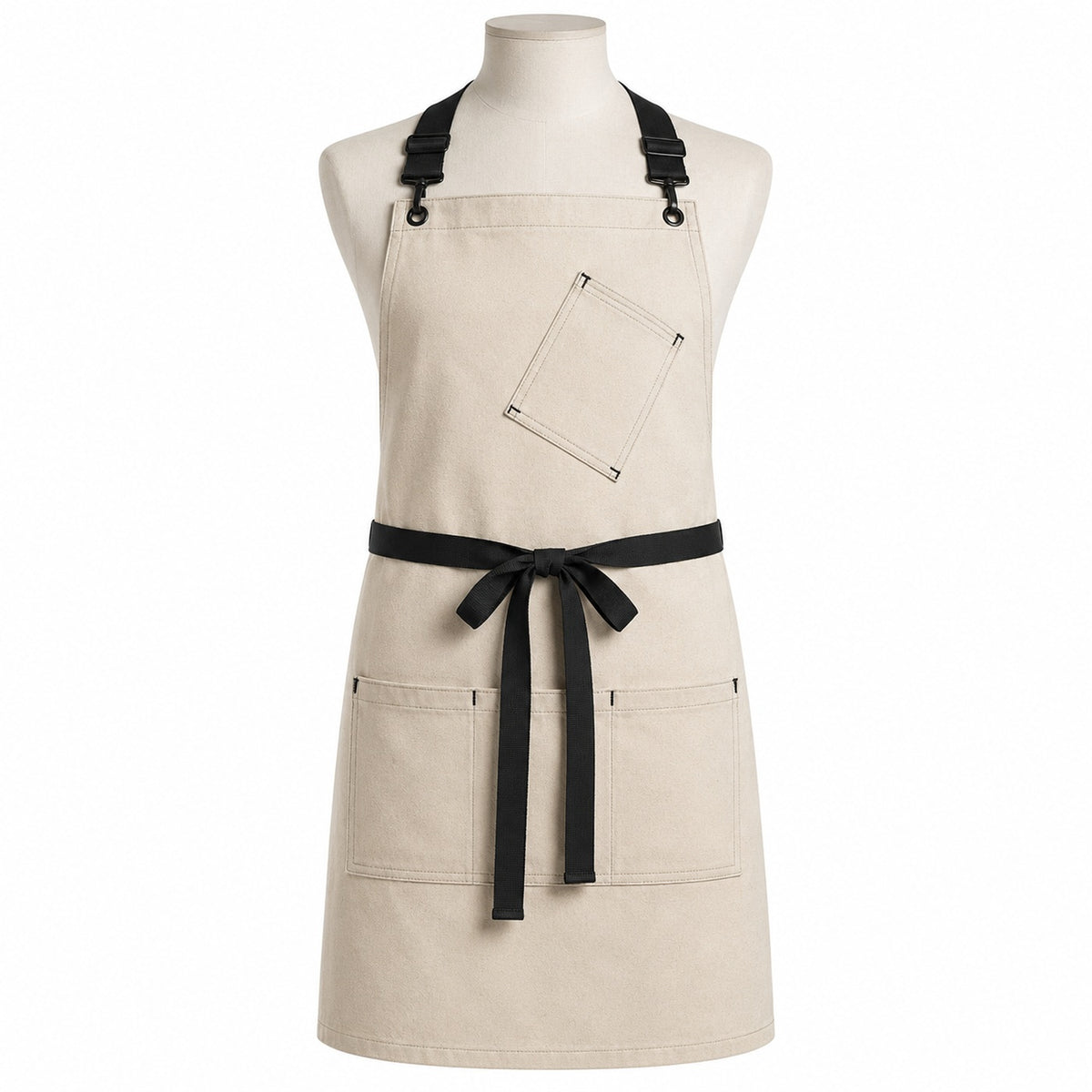 Primeval natural chef apron with black straps and utility pockets displayed on a dress form