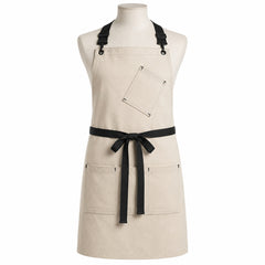Primeval natural chef apron with black straps and utility pockets displayed on a dress form