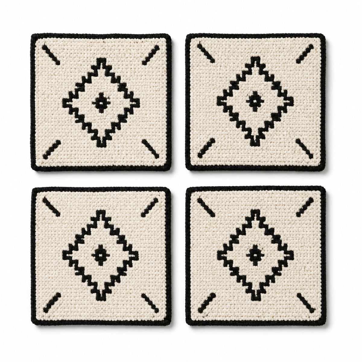Natural black tufted geometric coaster set on a clean white background