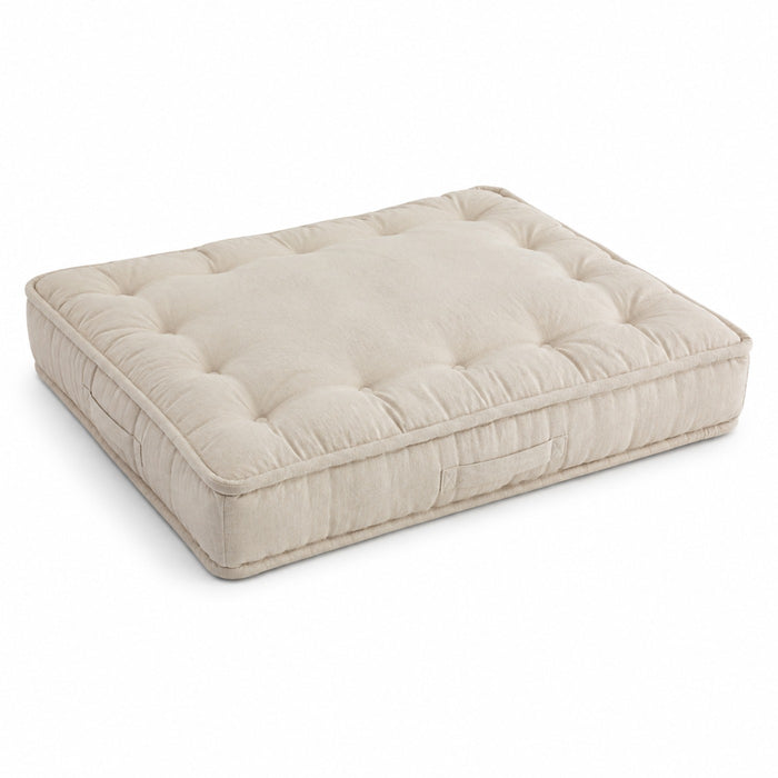 Natural beige square floor cushion with deep button-style tufting on white background