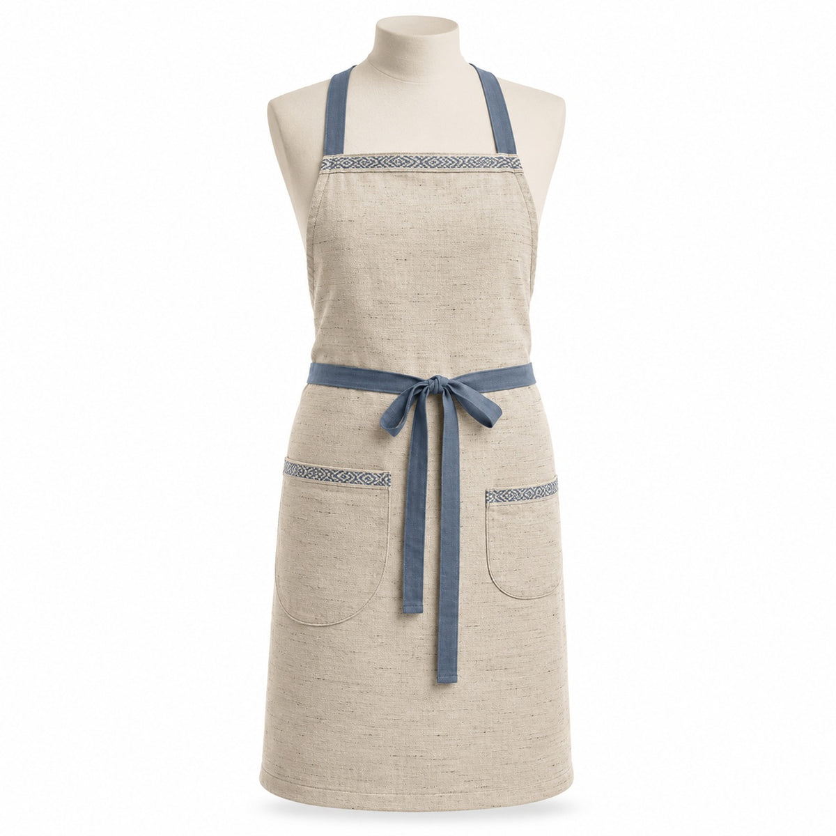 Primeval natural chef apron with dusty blue straps and pocket details displayed on a dress form