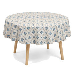 Primeval natural muted blue beige floral geometric tablecloth displayed on a round dining table