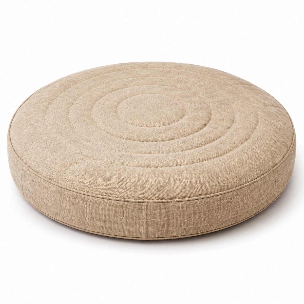 Natural beige round floor cushion with concentric stitched rings on white background