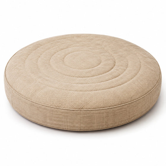 Natural beige round floor cushion with concentric stitched rings on white background