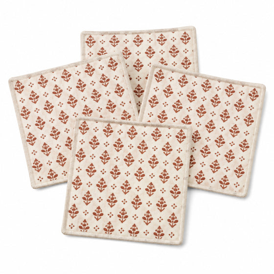 Natural rust block print coaster set on a clean white background