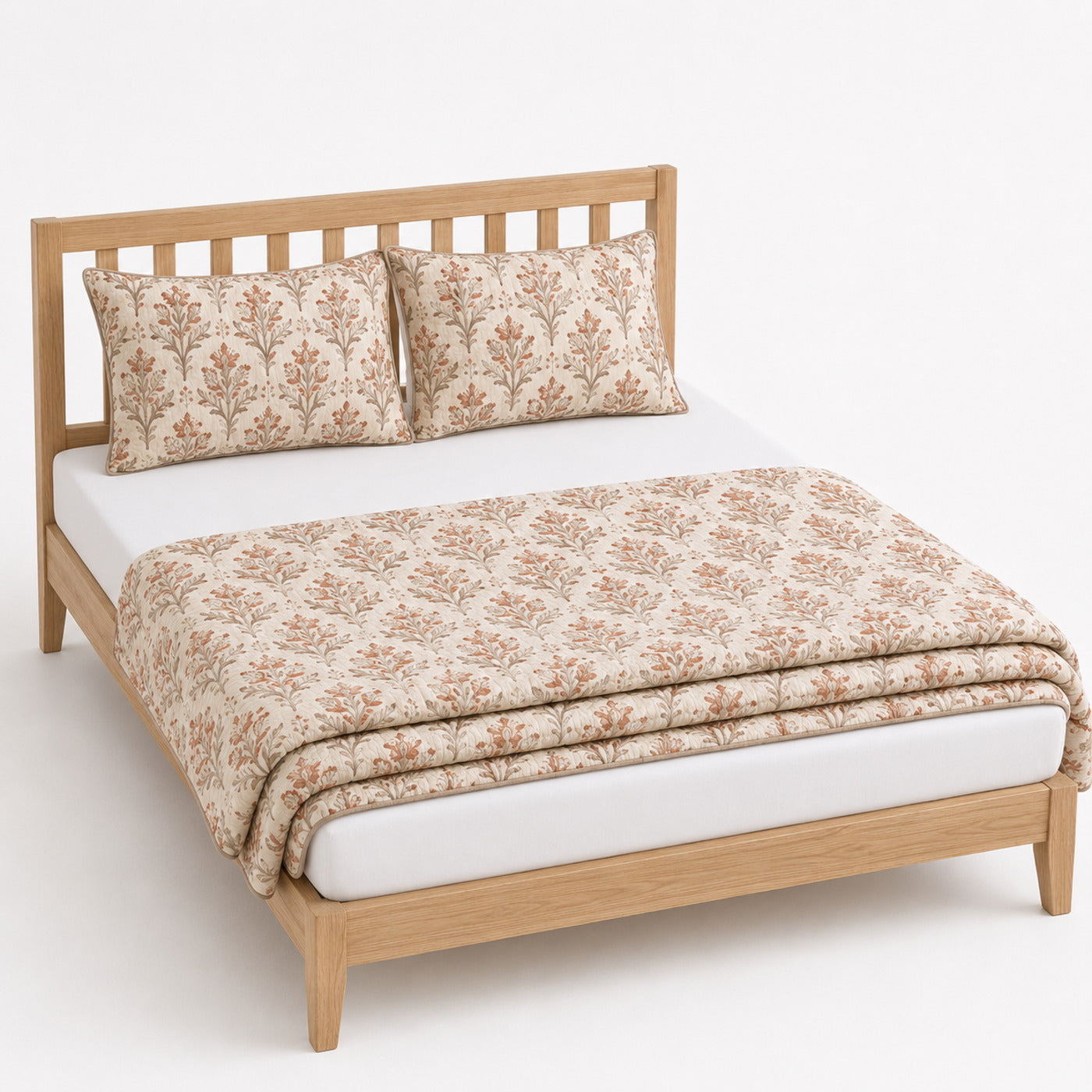 Natural terracotta and taupe botanical cotton quilt, folded with matching pillows for wholesale bedding sourcing