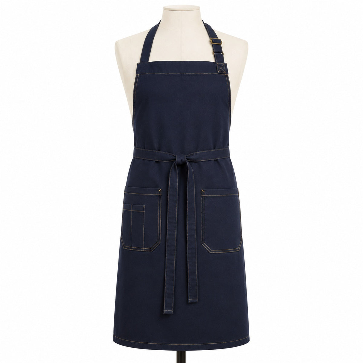 Primeval navy chef apron with beige contrast stitching displayed on a dress form