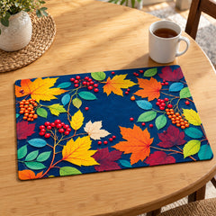 Midnight navy rectangular placemat covered with bright yellow orange teal and magenta tropical leaves berries and flowers on a wooden dining table