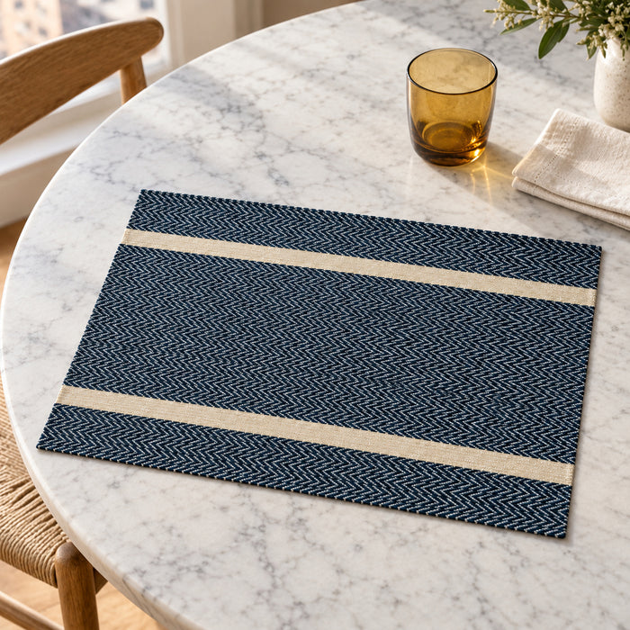 Midnight navy rectangular placemat with two wide ivory horizontal bands and fine herringbone-style texture on a white marble dining table