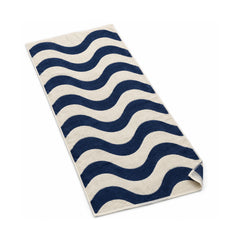Navy and cream wavy stripe beach towel with a modern coastal pattern.