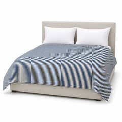 Primeval navy ivory fine stripe duvet cover displayed on a styled bed against a clean white studio background