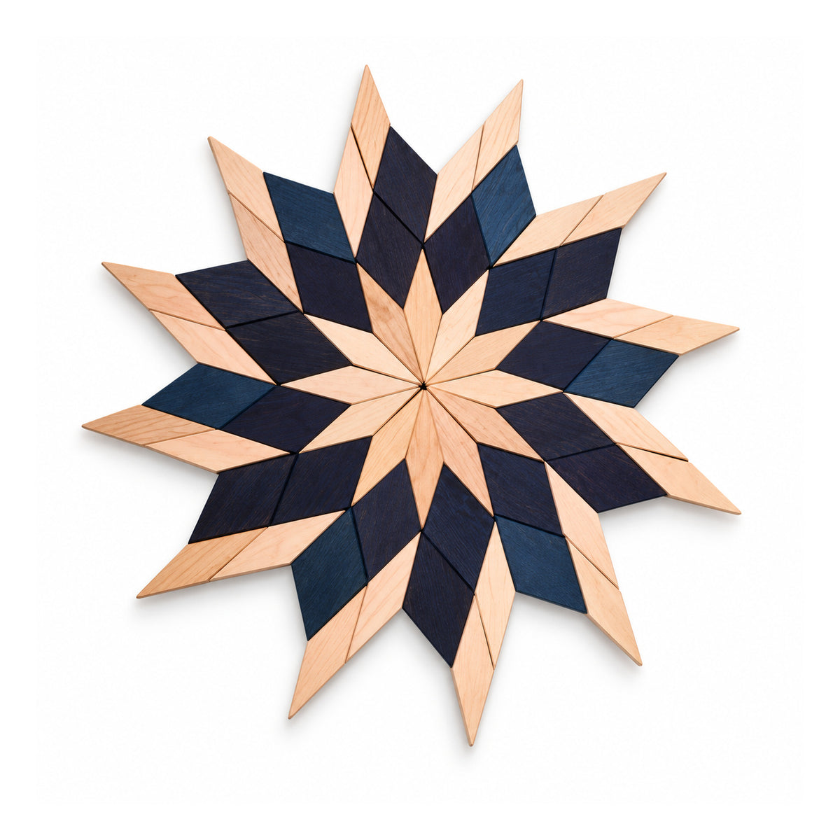 Large radial wooden starburst wall art with sharp layered rays in alternating pale natural wood and dark navy-black tones