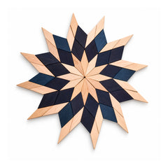 Large radial wooden starburst wall art with sharp layered rays in alternating pale natural wood and dark navy-black tones