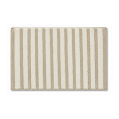 Neutral beige and ivory striped textured bath mat on white background