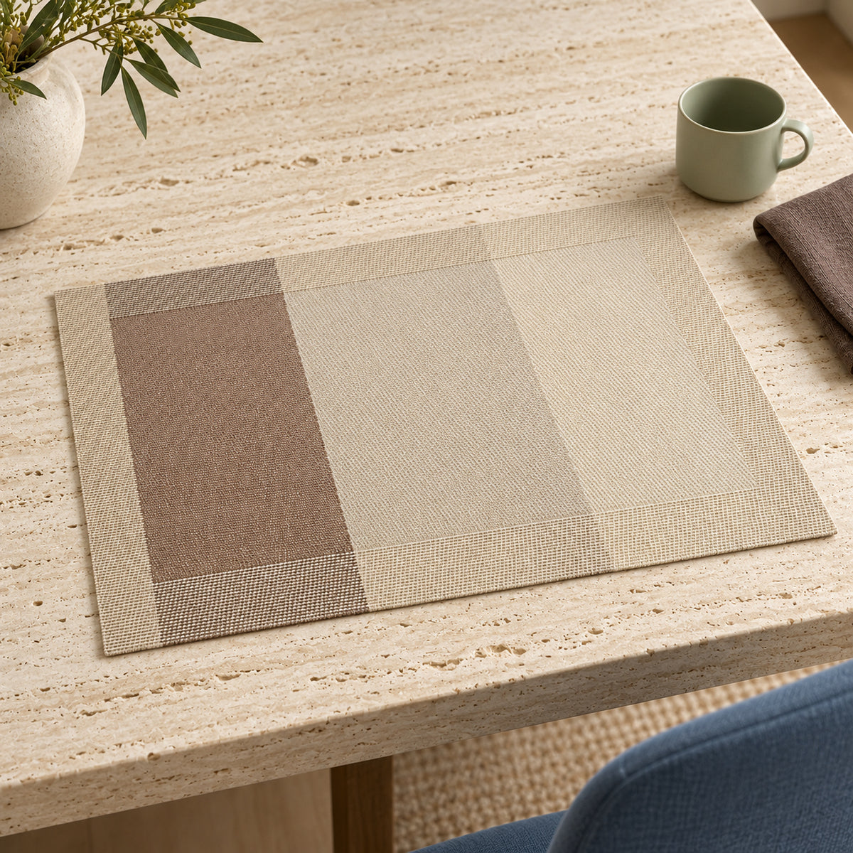 Rectangular dining placemat with calm colour block panels in taupe beige sand and ivory on a pale stone table