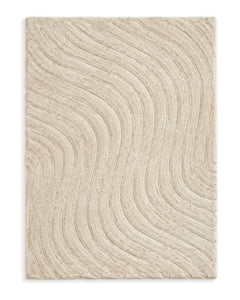 Oatmeal shaggy area rug with sculpted flowing line texture on a white background.