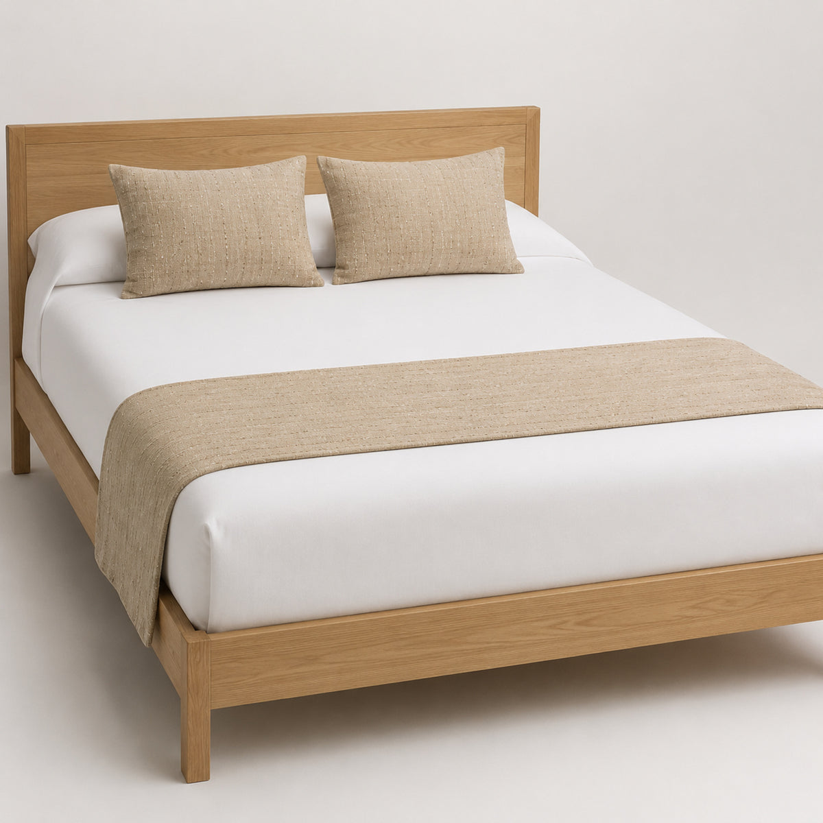 Oatmeal woven-texture bed runner presented on white bedding for wholesale hospitality and private-label home textile sourcing